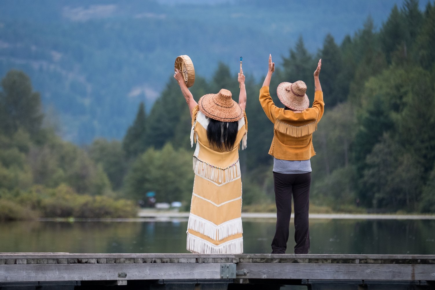 Female First Nations singing and blessing nature.